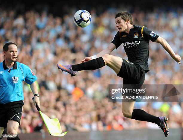 Manchester City's Adam Johnson jumps for the ball against Arsenal during the Premiership match at the Emirates Stadium in London on April 24, 2010....