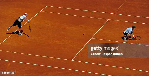 Lleyton Hewitt of Australia serves the ball flanked by his doubles partner Mark Knowles of the Bahamas during the final doubles match against Daniel...