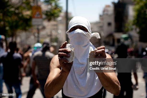 Palestinian youth holds stones during clashes on April 25, 2010 in the Arab east Jerusalem neighborhood of Silwan. Palestinian protesters hurled...