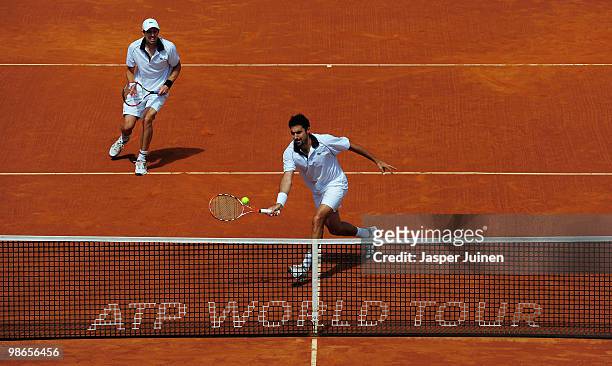 Nenad Zimonjic of Serbia plays a backhand flanked by his doubles partner Daniel Nestor Canada to Lleyton Hewitt of Australia and Mark Knowles of the...
