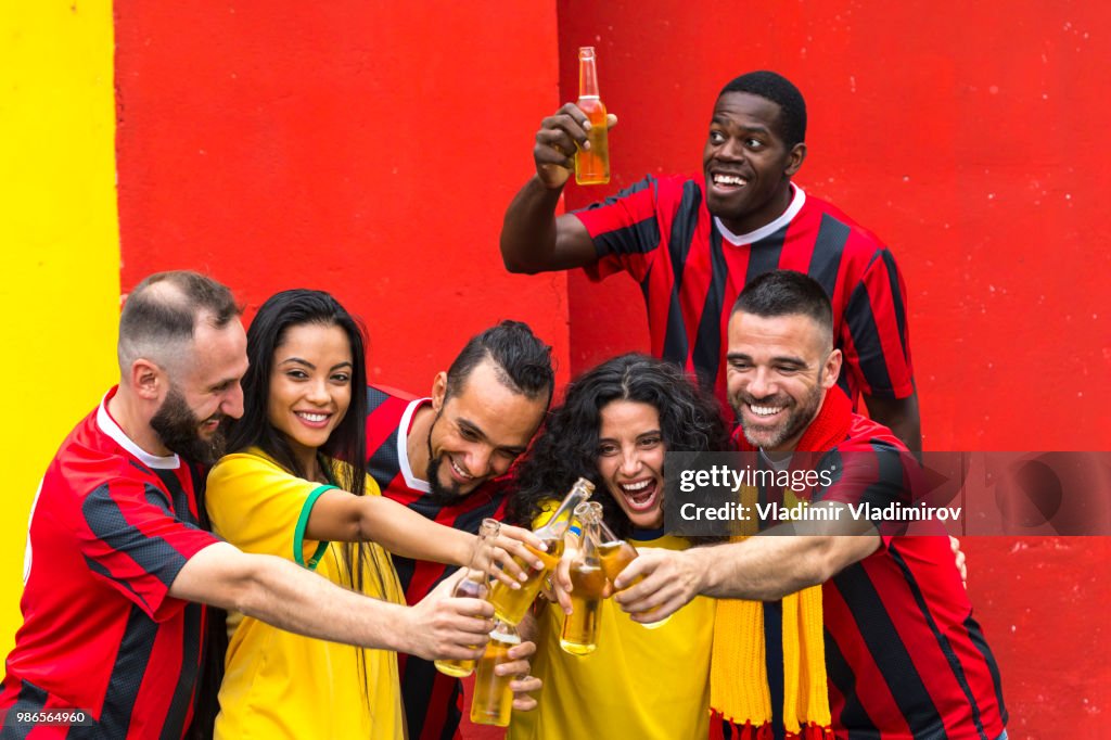 Cheerful fans cheering and drinking beer