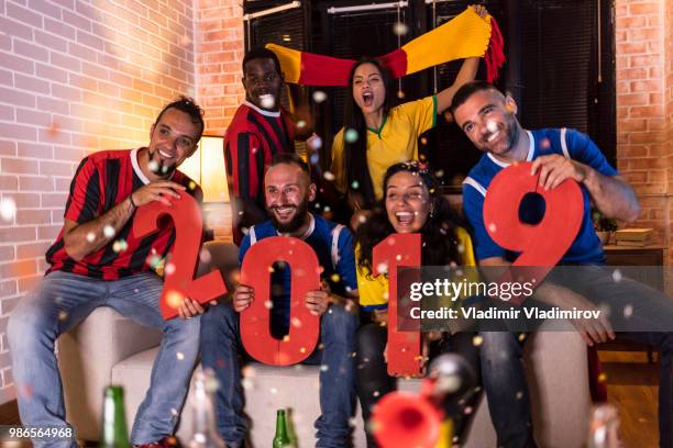 excited friends celebrating new year - new sport content stock pictures, royalty-free photos & images