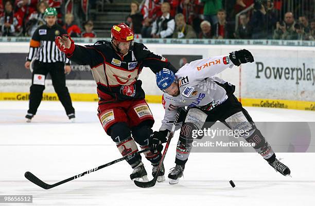 Sascha Goc of Hannover and Darin Olver of Augsburg battle for the puck during the DEL play off final match between Hannover Scorpions and Augsburger...