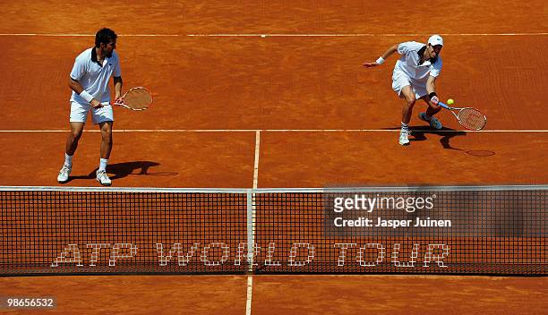 Daniel Nestor of Canada plays a backhand flanked by his doubles partner Nenad Zimonjic of Serbia to Lleyton Hewitt of Australia and Mark Knowles of...