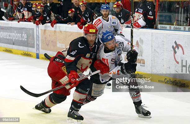 Sascha Goc of Hannover and Darin Olver of Augsburg battle for the puck during the DEL play off final match between Hannover Scorpions and Augsburger...