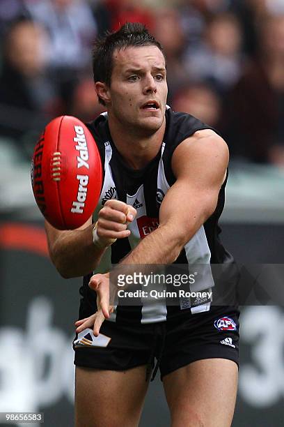 Nathan Brown of the Magpies handballs during the round five AFL match between the Collingwood Magpies and the Essendon Bombers at Melbourne Cricket...