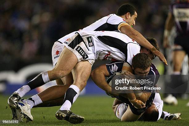 Ryan Hoffman of the Storm is tackled during the round seven NRL match between the Melbourne Storm and the Warriors at Etihad Stadium on April 25,...