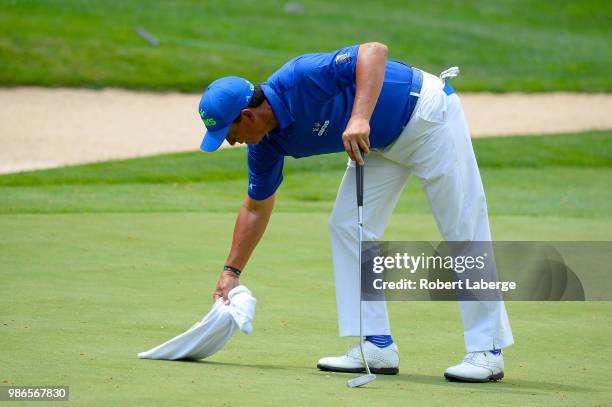 Tom Pernice Jr. Brushes leaves off the fifth green during round one of the U.S. Senior Open Championship at The Broadmoor Golf Club on June 28, 2018...