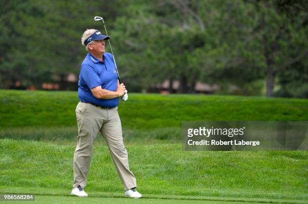Colin Montgomerie of Scotland makes an approach shot on the fifth hole during round one of the U.S. Senior Open Championship at The Broadmoor Golf...