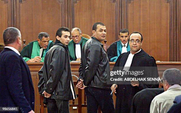 Independent magazine Tel Quel's journalists Ahmed Benchemsi and Karim Boukhari , prosecuted for libellous reports, wait besides their two lawyers 28...