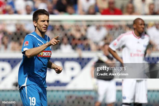 Vedad Ibisevic of Hoffenheim celebrates his team's first goal as Jerome Boateng of Hamburg reacts during the Bundesliga match between 1899 Hoffenheim...