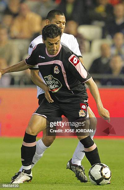 Valencia's Dutch defender Hedwiges Maduro vies for the ball with Deportivo Coruna's forward Riki Castro during their Spanish league football match at...