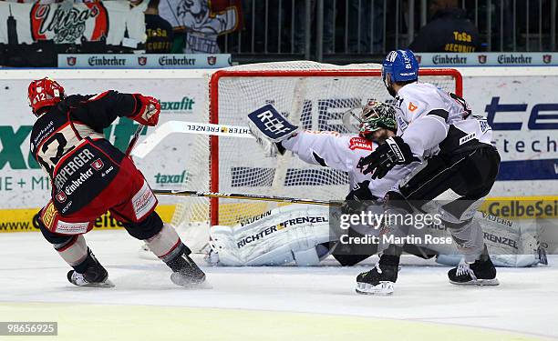 Chris Herperger of Hannover scores over Augsburg'd goalkeeper Dennis Endras his team's 2nd goal during the DEL play off final match between Hannover...