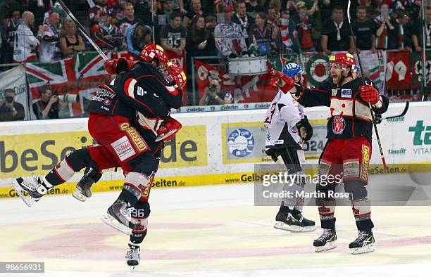 Chris Herperger, Andre Reiss and Adam Mitchel of Hannover celebrate their team's 2nd goal during the DEL play off final match between Hannover...