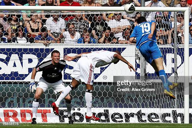 Vedad Ibisevic of Hoffenheim scores his team's second goal against Jerome Boateng and goalkeeper Frank Rost of Hamburg during the Bundesliga match...