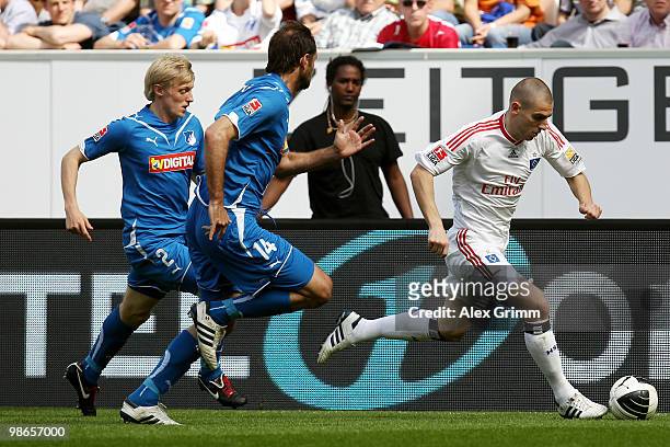 Mladen Petric of Hamburg is challenged by Josip Simunic and Andreas Beck of Hoffenheim during the Bundesliga match between 1899 Hoffenheim and...