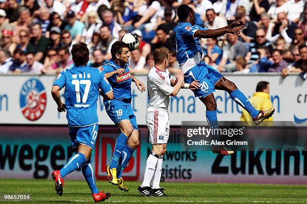 David Jarolim of Hamburg is challenged by Tobias Weis, Vedad Ibisevic and Chinedu Obasi of Hoffenheim during the Bundesliga match between 1899...