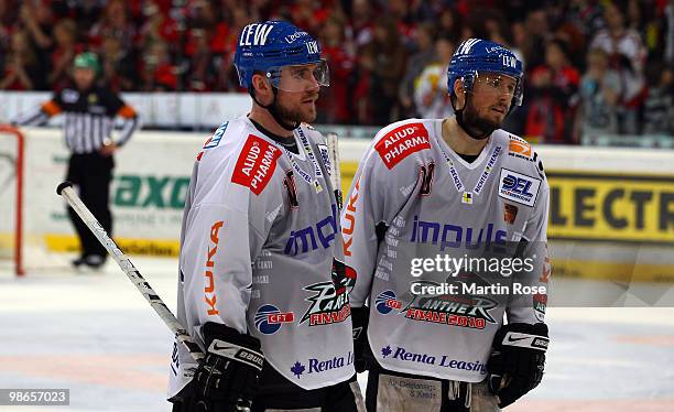 Gordon Rhett and Tyler Beechy of Augsburg look dejected during the DEL play off final match between Hannover Scorpions and Augsburger Panther at TUI...