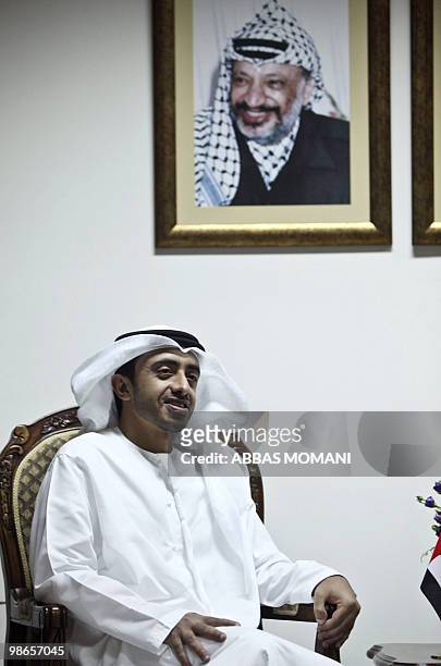 Emirati Foreign Minister Sheikh Abdullah bin Zayed al-Nahayan is pictured under a portrait of late Palestinian leader Yasser Arafat during his...