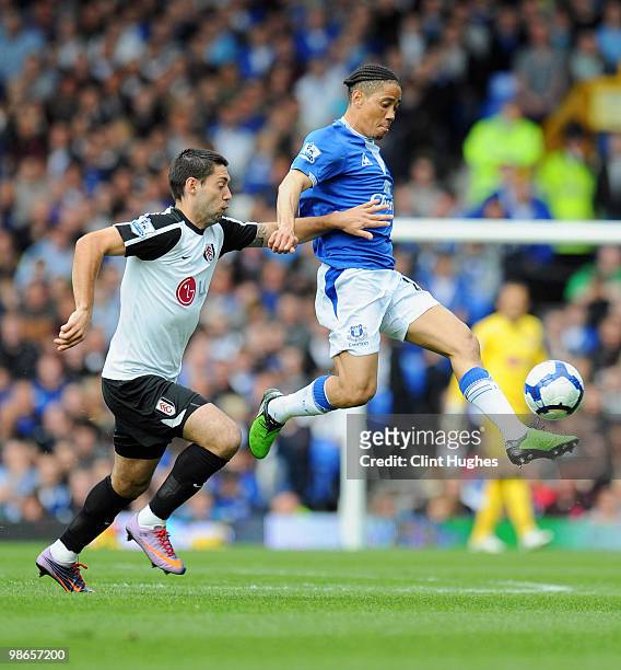 Steven Pienaar of Everton battles for the ball with Clint Dempsey of Fulham during the Barclays Premier League match between Everton and Fulham at...