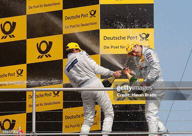 Champagne douche between Bruno Spengler of Canada and Gary Paffet of Great Britain after the DTM 2010 German Touring Car Championship on April 25,...