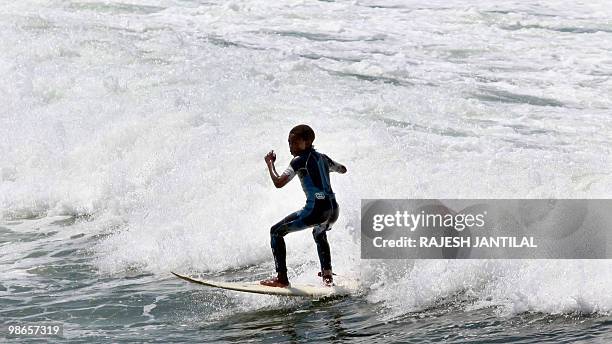 Marine VEITH A street child learns to surf at Durban's North Beach on February 13, 2010. Durban is one of nine South African cities hosting the 2010...
