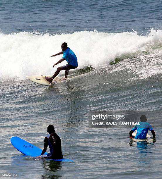 Marine VEITH Street children learn to surf at Durban's North Beach on February 13, 2010. Durban is one of nine South African cities hosting the 2010...