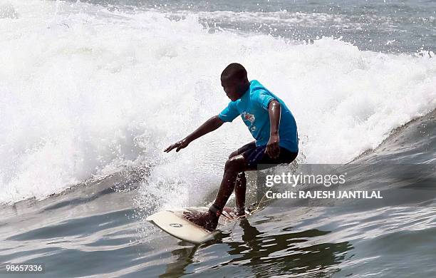 Marine VEITH A street child learns to surf at Durban's North Beach on February 13, 2010. Durban is one of nine South African cities hosting the 2010...