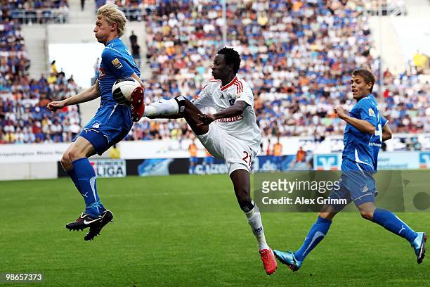 Jonathan Pitroipa of Hamburg is challenged by Andreas Beck and Boris Vukcevic of Hoffenheim during the Bundesliga match between 1899 Hoffenheim and...