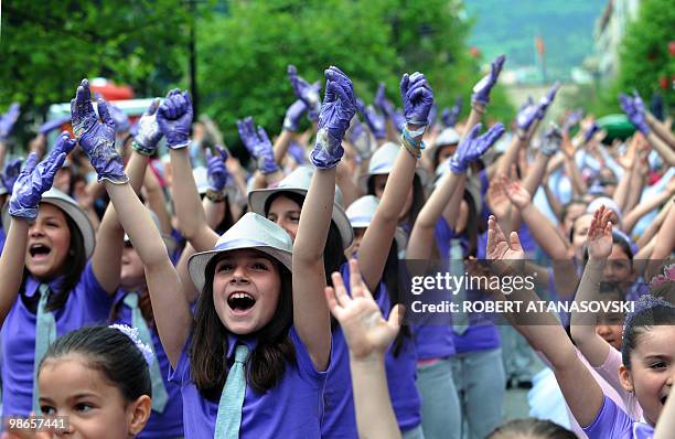 Participants from all over Macedonia dance to the music of Carmina Burana on a parade in the centre of Skopje on April 25 celebrating of the closing...