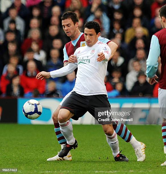 Maxi Rodriguez of Liverpool competes with Danny Fox of Burnley during the Barclays Premier League match between Burnley and Liverpool at Turf Moor on...