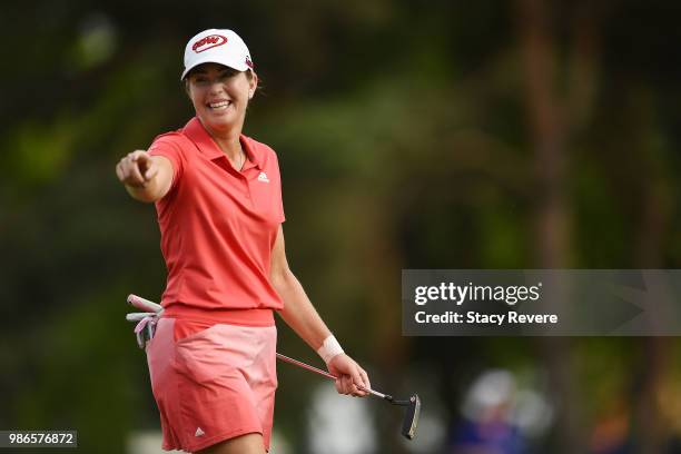 Paula Creamer points to a fan as she walks across the ninth green during the first round of the KPMG Women's PGA Championship at Kemper Lakes Golf...