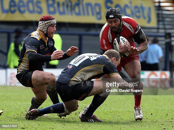 Sam Tuitupou of Worcester is stopped by Andy Titterrell and Ceiron Thomas during the Guinness Premiership match between Leeds Carnegie and Worcester...