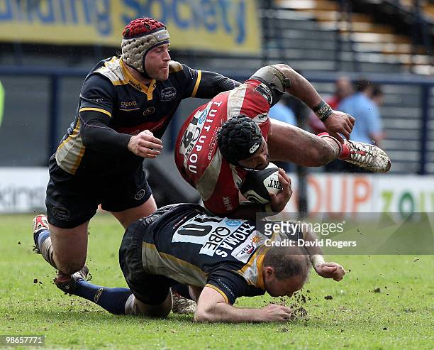 Sam Tuitupou of Worcester is stopped by Andy Titterrell and Ceiron Thomas during the Guinness Premiership match between Leeds Carnegie and Worcester...