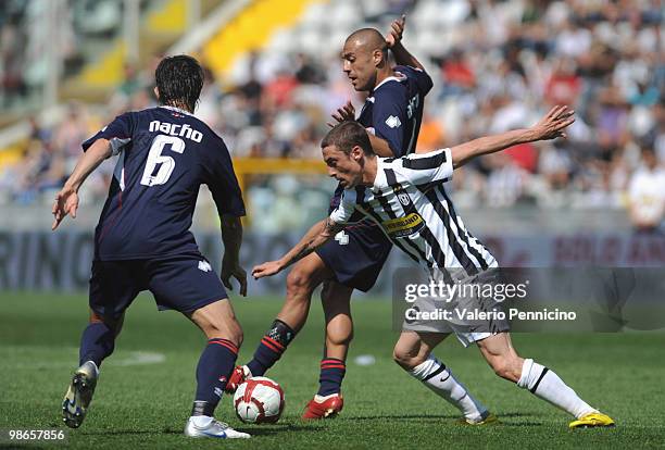 Claudio Marchisio of Juventus FC competes for the ball with Sergio Bernardo Almiron and Falque Silva Yago of AS Bari during the Serie A match between...