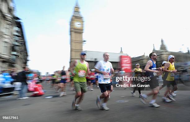 Participants run through Parliament Square in Westminster during the 2010 Virgin London Marathon on April 25, 2010 in London, England.