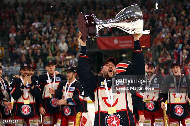 Thomas Dolak of Hannover celebrates with the trophy after winning the DEL play off final match between Hannover Scorpions and Augsburger Panther at...