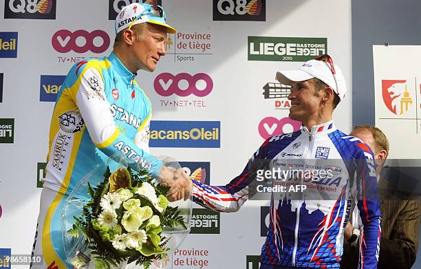 Kazakhstan's Alexander Vinokourov of team Astana shakes hands with Russian Alexander Kolobnev of team Katusha on the podium at the end of the 96th...