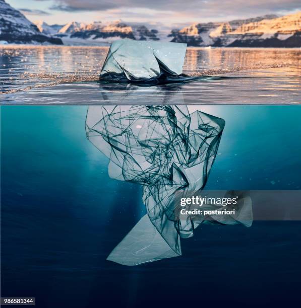 iceberg of garbage plastic floating in ocean with greenland back - posteriori stock pictures, royalty-free photos & images