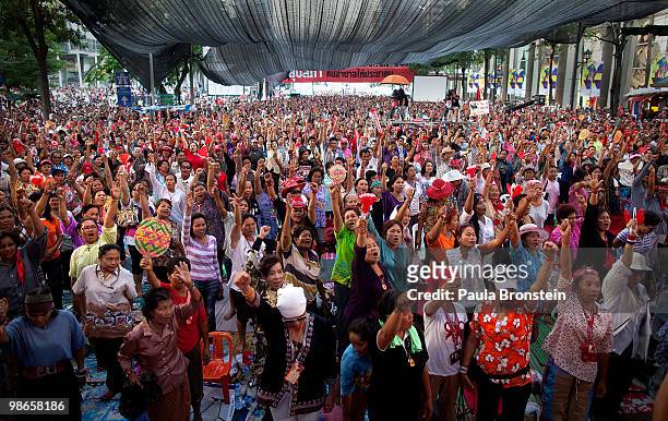Red shirt protesters cheer after singing the national anthem April 25, 2010 in Bangkok Thailand. All protesters were told to remove their red...