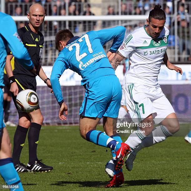 Igor Denisov of FC Zenit St. Petersburg battles for the ball with Blago Georgiev of FC Terek Grozny during the Russian Football League Championship...