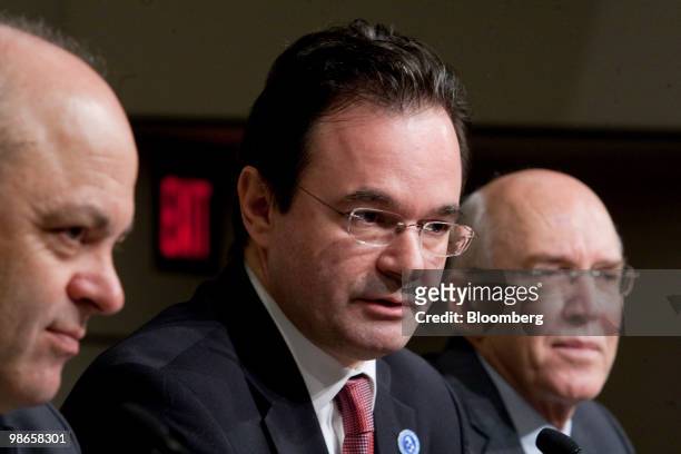George Papaconstantinou, Greece's finance minister, center, speaks during a news conference with Panagiotis Roumeliotis, Greek representative to the...