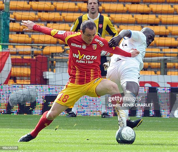Lens's French midfielder Sebastien Roudet vies with Valenciennes's French midfielder Remi Gomis during the French L1 football match Lens vs...