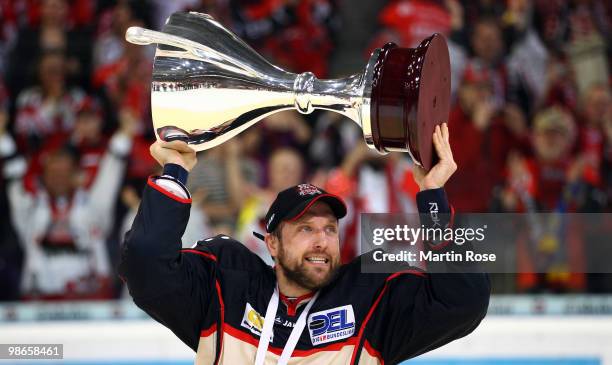 Martin Hlinka of Hannover celebrates with the trophy after winning the DEL play off final match between Hannover Scorpions and Augsburger Panther at...