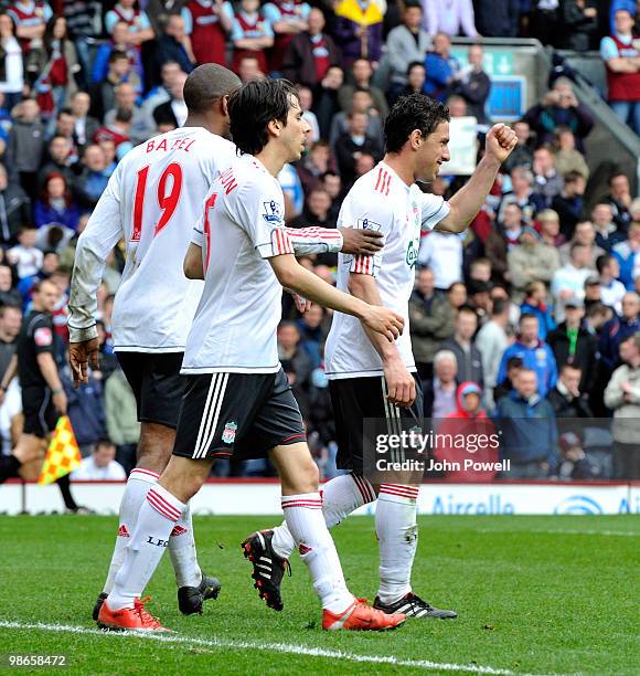 Maxi Rodriguez of Liverpool celebrates with team mates Yossi Benayoun and Ryan Babel after scoring his team's third goal and his first for the club...