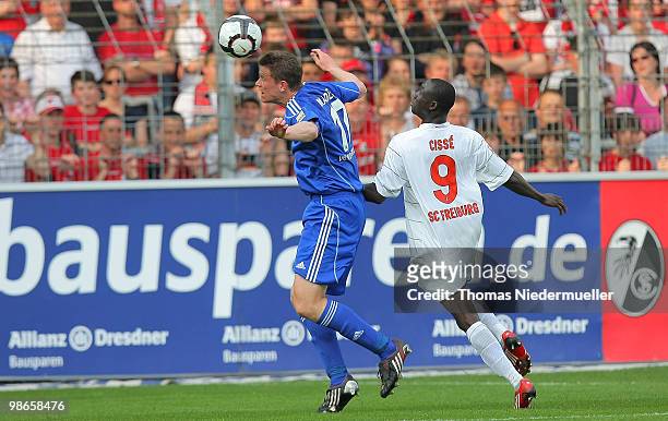 Alexander Madlung of Wolfsburg jumps for a header against Papiss Cisse of Freiburg during the Bundesliga match between SC Freiburg and VfL Wolfsburg...