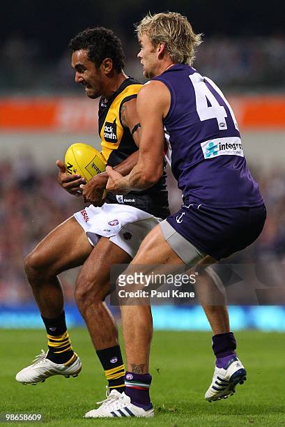 Richard Tambling of the Tigers marks in fornt of Paul Duffield of the Dockers during the round five AFL match between the Fremantle Dockers and the...