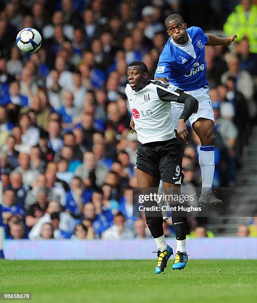Sylvain Distin of Everton battles for the ball with Stefano Okaka of Fulham during the Barclays Premier League match between Everton and Fulham at...