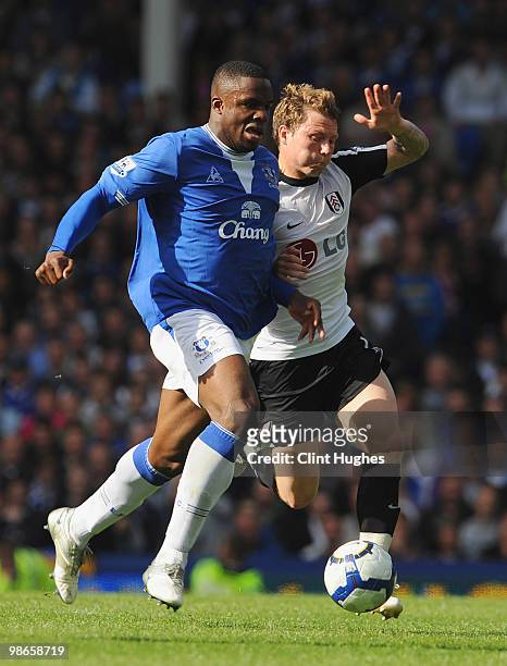 Victor Anichebe of Everton battles for the ball with Bjorn Helge Riise of Fulham during the Barclays Premier League match between Everton and Fulham...