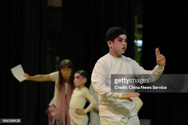 Schoolchildren prepare backstage prior to a Cantonese opera performance on June 26, 2018 in Hong Kong, China. Thirty-four children from Po Leung Kuk...